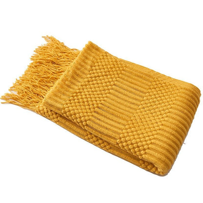 Dekorativt strikket pledd i beige